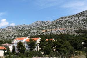 a view of a mountain with houses and trees at Apartments and rooms by the sea Starigrad, Paklenica - 6591 in Starigrad