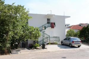 a car parked in front of a white house at Apartments by the sea Drvenik Donja vala, Makarska - 6701 in Drvenik