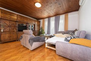 a living room with a bed and a couch at Apartments with a parking space Tucepi, Makarska - 6695 in Tučepi