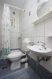a bathroom with a toilet and a sink at Apartments and rooms by the sea Makarska - 6839 in Makarska