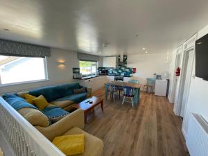 a living room with a couch and a table at Driftwood Seagrass in Par