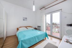 a bedroom with a bed and a large window at Apartments by the sea Podaca, Makarska - 6735 in Podaca