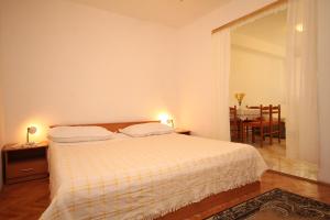 ein Schlafzimmer mit einem Bett und ein Esszimmer mit einem Tisch in der Unterkunft Apartments with a parking space Tucepi, Makarska - 6857 in Tučepi
