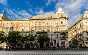 a large building on a street in a city at Cozy 2 Bedroom Apartment In Terez Boulevard. in Budapest