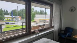 a bedroom window with a view of a parking lot at Gracia's Kitchen & Inn in Valtimo