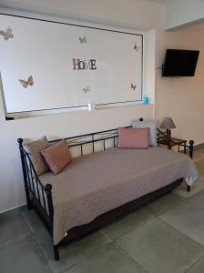 a bed in a room with a large window at PHOENIX apartment near the airport in Markopoulo