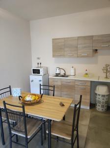 a kitchen with a table with a bowl of fruit on it at PHOENIX apartment near the airport in Markopoulo