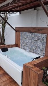 a bath tub sitting on top of a wooden floor at Nostravila in Lonavala