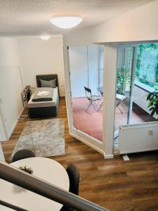 a living room with a view of a balcony at ND Hotels & Apartments Bottrop am Centro in Bottrop
