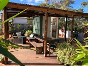 a wooden pergola with a bench on a patio at 1166 on Booner - Hawks Nest in Hawks Nest