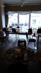 a restaurant with tables and chairs and a large window at The Manuela Rose in Blackpool