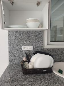 a kitchen counter with a sink and a basket of food at Villa de luxe avec piscine sans vis à vis Midoun in Aghīr