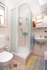 a bathroom with a shower and a toilet and a sink at Apartments by the sea Drasnice, Makarska - 6697 in Drasnice