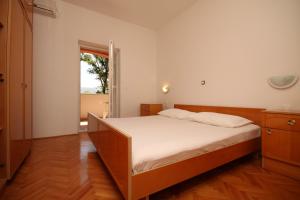 a bedroom with a large bed and a window at Rooms by the sea Metajna, Pag - 6487 in Metajna