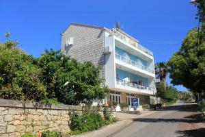 a building on the side of a street at Rooms with a swimming pool Cavtat, Dubrovnik - 5222 in Cavtat
