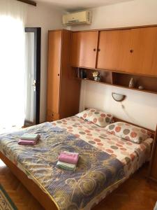 a bedroom with a bed with two books on it at Rooms by the sea Pomena, Mljet - 4929 in Pomena