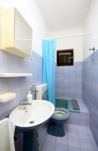 a blue bathroom with a toilet and a sink at Rooms by the sea Pomena, Mljet - 4929 in Pomena