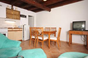 a living room with a table and chairs and a kitchen at Holiday house with a parking space Sali, Dugi otok - 8138 in Sali