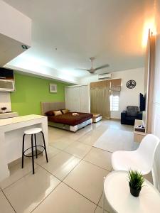 a living room with a bed and a table and chairs at Private Studio Viana Court Service Apartment 3 with private parking in Kota Bharu