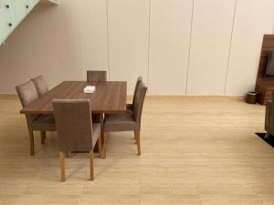 a wooden table and chairs in a room at Half Moon Al Khobar Resort in Half Moon Bay