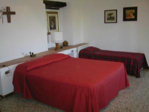 Postel nebo postele na pokoji v ubytování Agriturismo Poggio ai Grilli