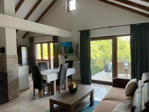 a living room with a table and a dining room at Vikendica Oliver in Medovdolac