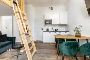 a ladder in a living room with a table and chairs at Homewell Apartments Wilson Park II in Poznań