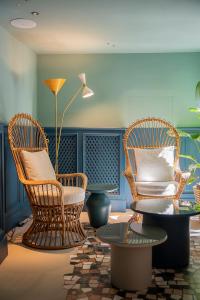 a room with three chairs and a table and a lamp at Hotel Priori Secret Garden in Perugia