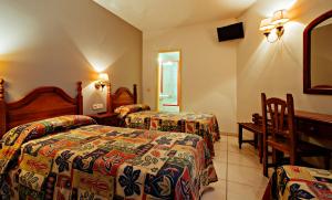 Un pat sau paturi într-o cameră la Hotel BONCOMPTE