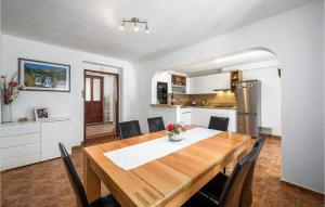 a kitchen and dining room with a wooden table at Holiday Home Svetvincenat With Outdoor Swimming Pool 207 in Svetvinčenat