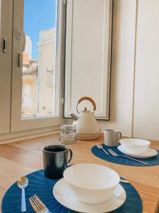 a table with plates and cups and a tea kettle at Concha Setúbal Miradouro in Setúbal +38 photos