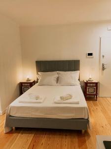 a bedroom with a large bed with two night stands at Concha Setúbal Miradouro in Setúbal