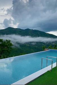 a swimming pool with a view of a mountain at Captain’s Villa and Campsite in Cebu City