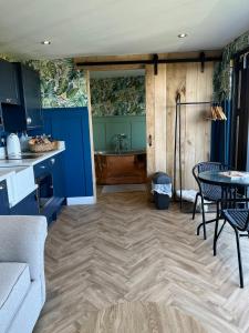 a kitchen with a table and a kitchen with a tub at The Rhossili bay secret in Swansea