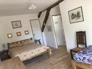 a bedroom with a bed and a table at La Ville de Mainguy in Josselin