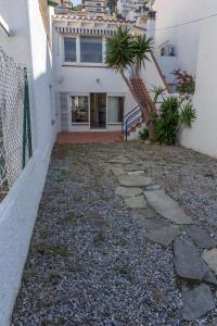 a stone walkway leading to a house with a staircase at Agi Port de Rosas in Roses