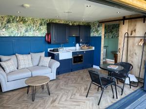 a living room with a couch and a table at The Rhossili bay secret in Swansea