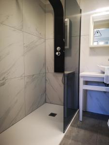 a shower with a glass door in a bathroom at 12 Gods Resort in Pylos