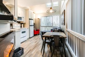 a kitchen and dining room with a table and chairs at Le Villageois by Gestion ELITE in Mont-Tremblant