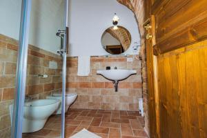 a bathroom with a sink and a toilet and a mirror at BB Casale La Selva Mosciano in Mosciano SantʼAngelo