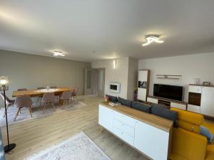 a living room with a couch and a dining room at Vila Novara V26 in Bordeiu