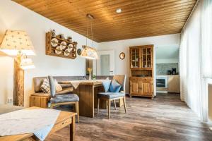 a kitchen and living room with a wooden ceiling at Ferienwohnanlage Oberaudorf in Oberaudorf