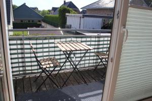 a pair of chairs and a table on a balcony at Ferienwohnung Störtebeker in Sandesneben +4 photos