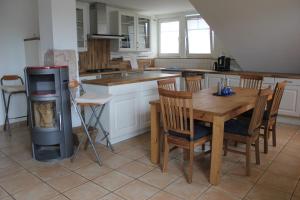 a kitchen with a wooden table and a stove at Ferienwohnung Störtebeker in Sandesneben