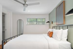 a bedroom with a white bed and a window at Abode Houston - Norfolk in Houston