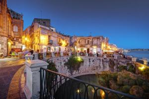 a group of buildings in a city at night at Home Sicily in Pachino