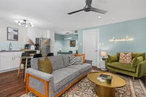 a living room with a couch and a table at Abode Houston - Norfolk in Houston