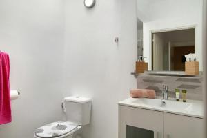 a white bathroom with a toilet and a sink at Estudio Massimo 7c in Las Palmas de Gran Canaria +20 photos