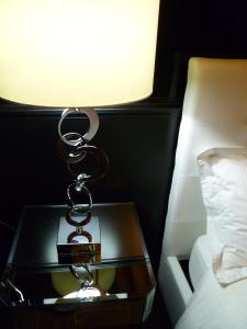 a lamp on a table next to a bed at Aux Portes d'Honneur in Cluny