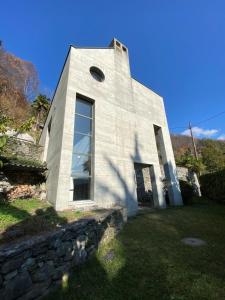 a white building with a stone wall at B1Verscio Villa Cavalli in Verscio